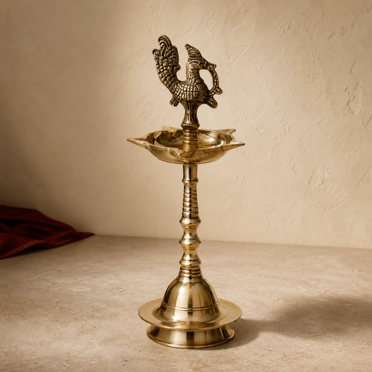 Mayura Deepa, a brass pooja, shown on a warm neutral surface
