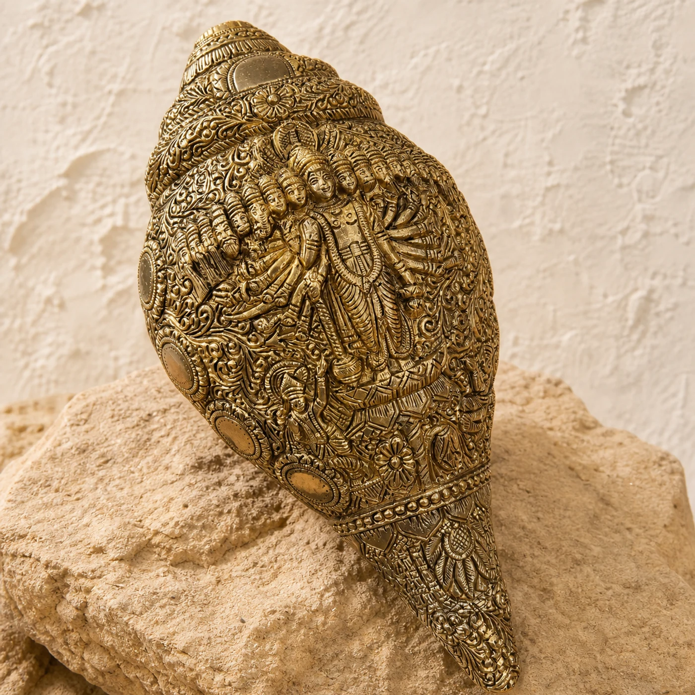 Vishwaroopa Shankh, a brass pooja, shown on a warm neutral surface